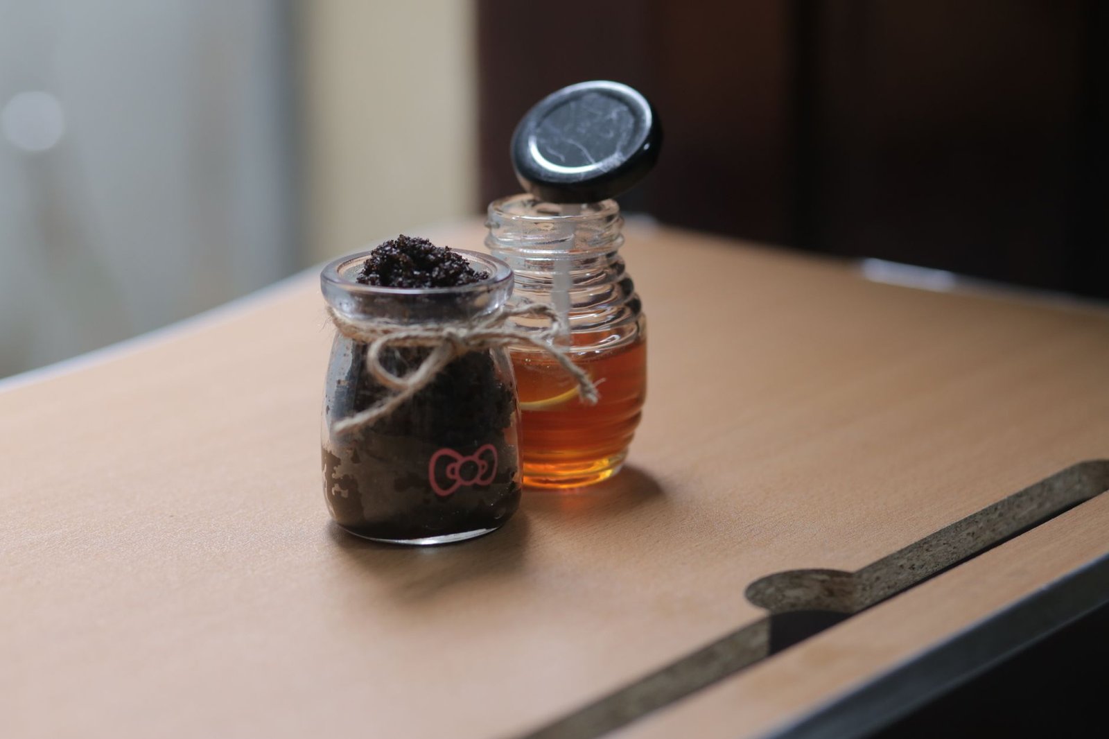 A body scrub sitting on a bathroom shelf