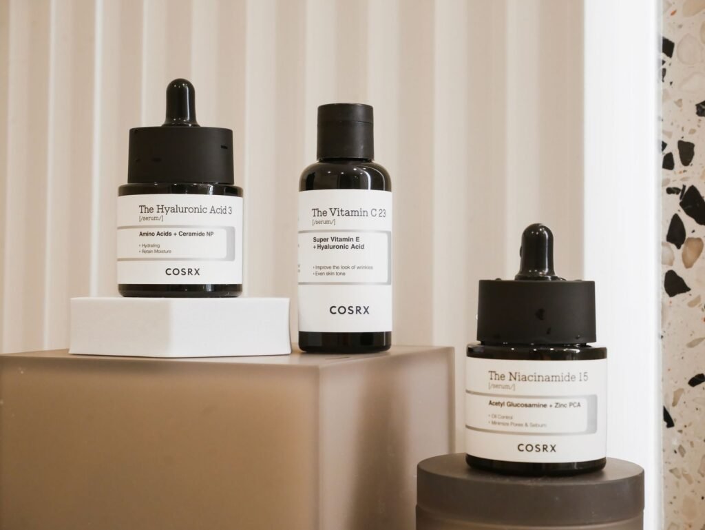 A niacinamide serum bottle photographed on a plain surface