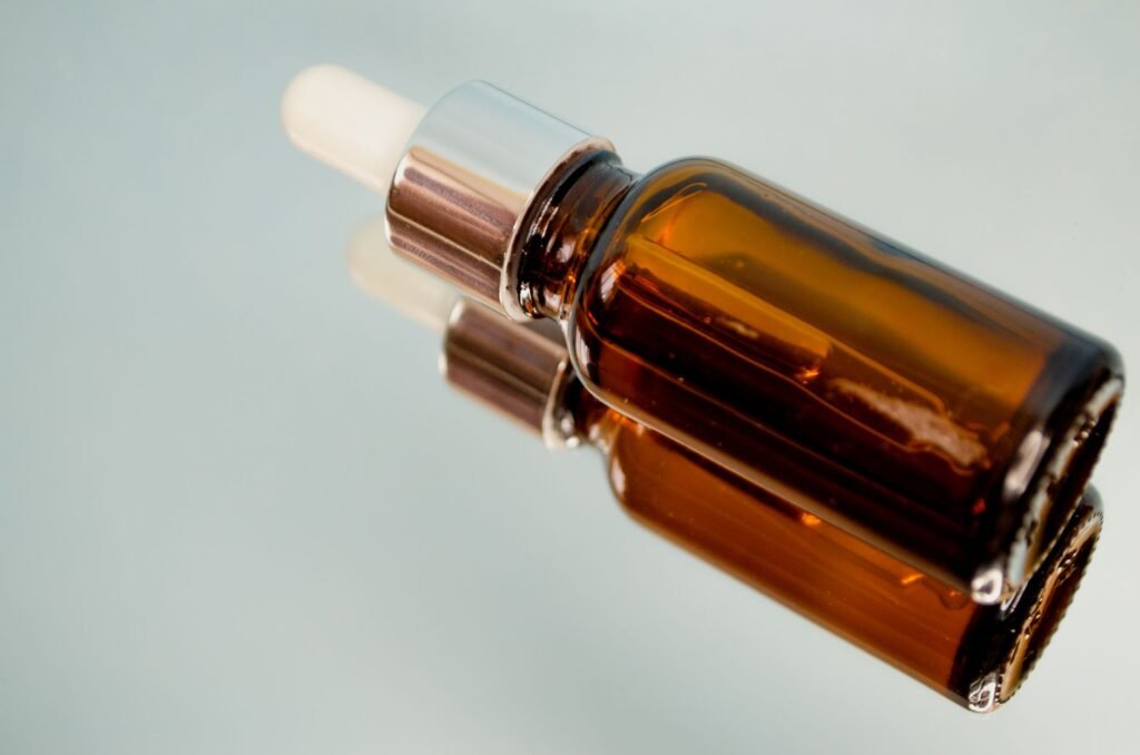 A retinol serum bottle with a glass dropper on a pale bathroom shelf