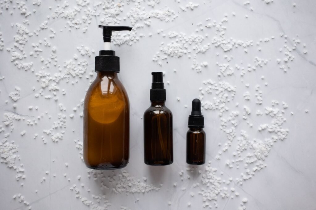 A group of plain, minimally labelled skincare bottles